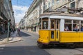 Very touristic place in the old part of Lisbon, with a traditional tram passing by in the city of Lisbon, Portugal. Royalty Free Stock Photo